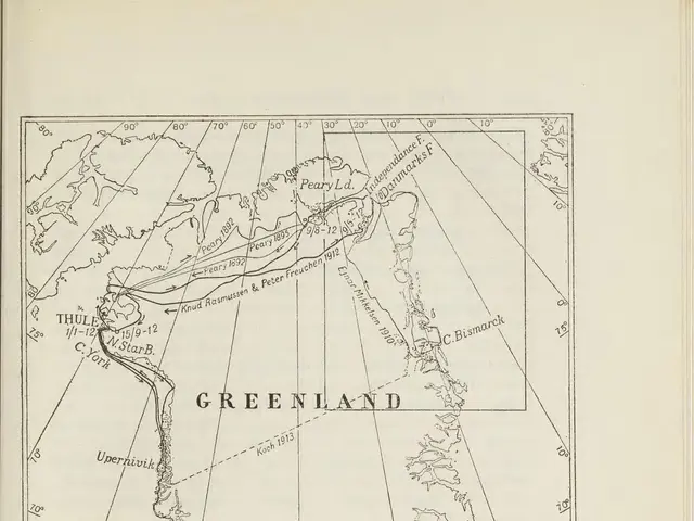 The image shows an open book with a map of Greenland on it. The map is detailed and shows the...