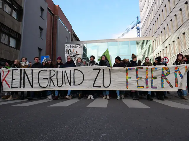 The image shows a group of people standing on the road, holding a banner that reads "Kein Grund zu...
