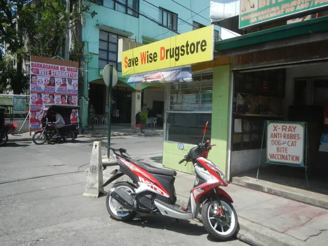 The image shows a red and white scooter parked on the side of the road in front of a drugstore....
