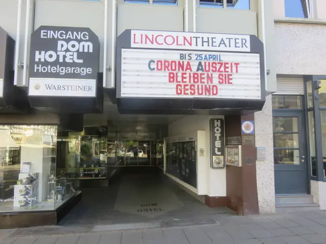 The image shows the Lincoln Theater in Berlin, Germany. It is a building with glass windows and...