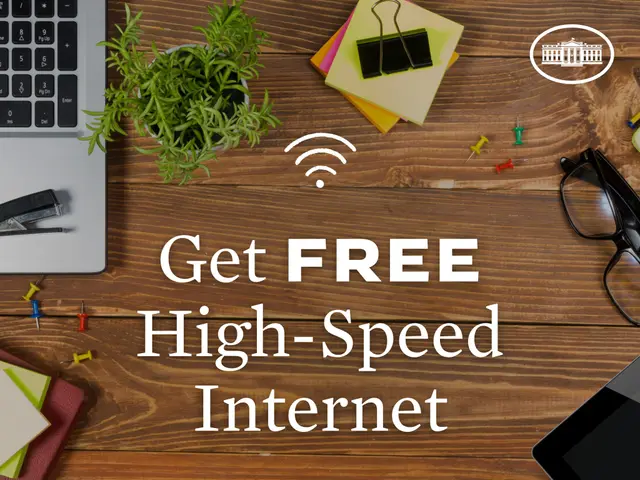 The image shows a wooden surface with a laptop, mouse, book, pen, spectacles, tablet, magnifying...