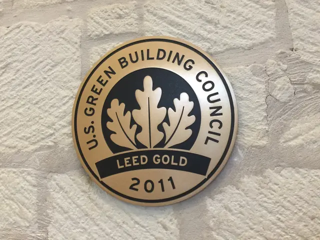 The image shows the logo of the U.S. Green Building Council on the side of a building. The logo...