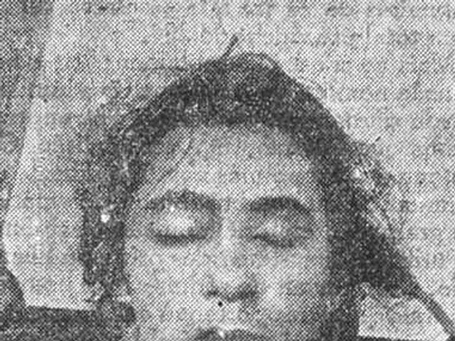 The image shows a black and white photo of a woman with her eyes closed, believed to be the first...