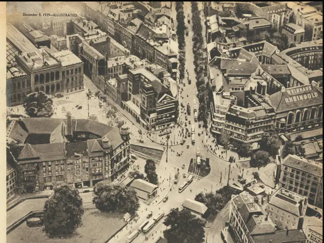 The image shows an old newspaper with a picture of a cityscape featuring buildings, trees, and...