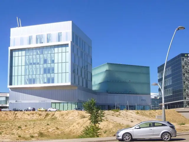 The image shows a large building with cars parked in front of it, surrounded by street poles,...