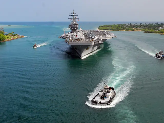 The image shows an aircraft carrier, the USS George H W Bush CVN-68, transiting the Gulf of Mexico....