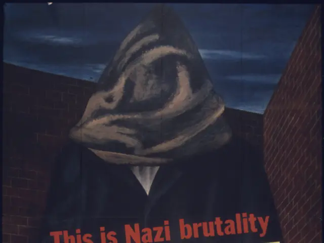 The image shows a poster on the wall with a person wearing a mask and the text "This is Nazi...