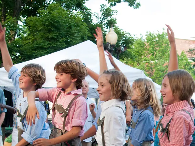 The image shows a group of children in traditional Bavarian clothing dancing on the street,...