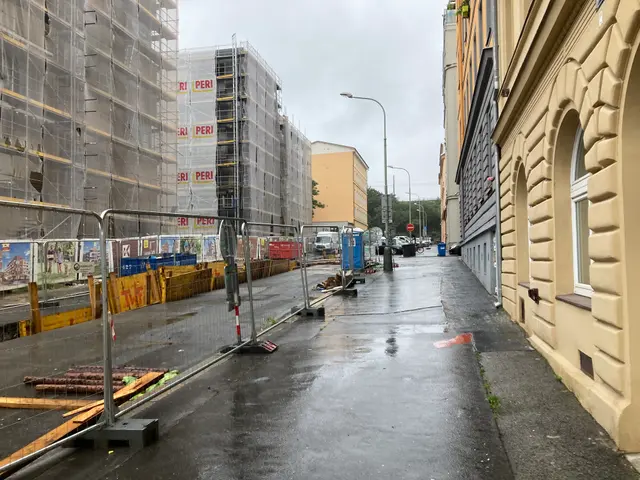 The image shows a street with a lot of construction equipment on the side of it, including...