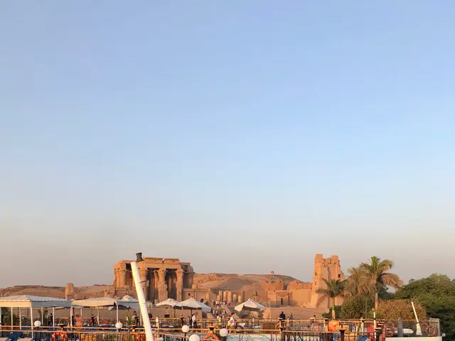 The image shows a group of cruise ships docked in the water near each other, with tubes, chairs,...