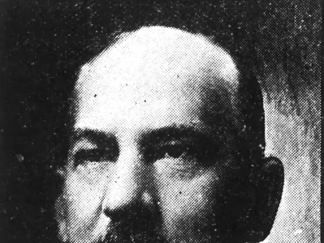 The image shows a black and white photo of Judge James S. Manning, wearing a suit and tie. At the...