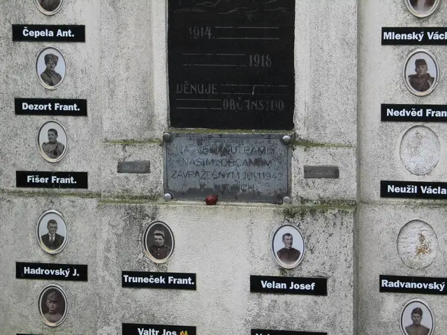 The image shows a wall with a plaque on it, featuring pictures of people and text. The plaque is...