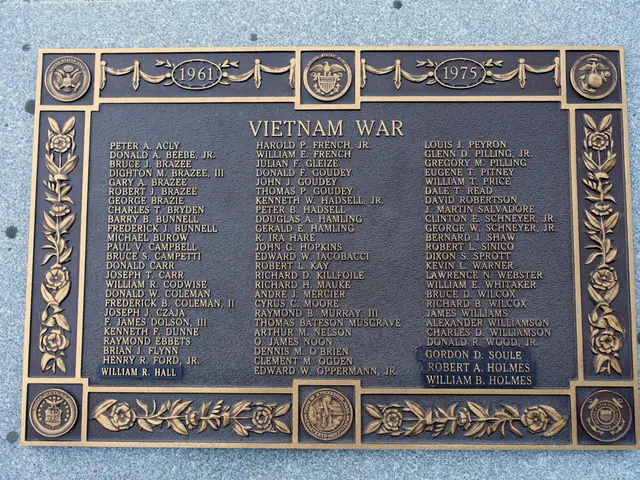 The image shows a plaque on the side of a building that reads "Vietnam War". The plaque is made of...