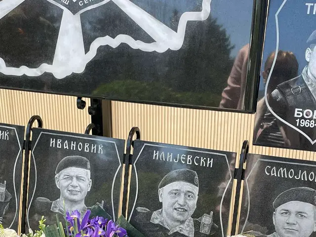 The image shows a memorial to the victims of the soviet war, with a bunch of flowers sitting on top...