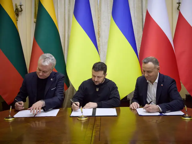 The image shows three men sitting at a table, signing papers with pens in their hands. On the table...