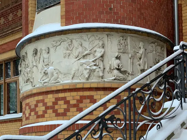 The image shows a brick building with a staircase covered in snow next to it. The stairs have...