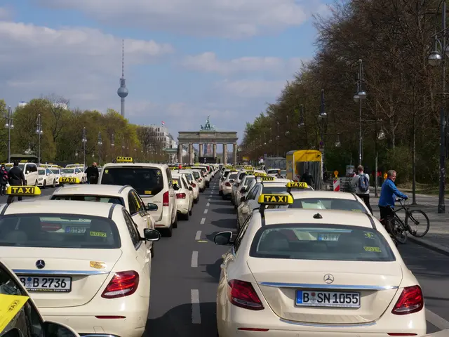 The image shows a long line of taxis parked on the side of a street in Berlin, Germany. There are...