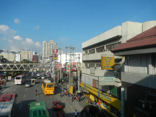 The image shows a bustling city street filled with lots of traffic, including cars, buses, and...