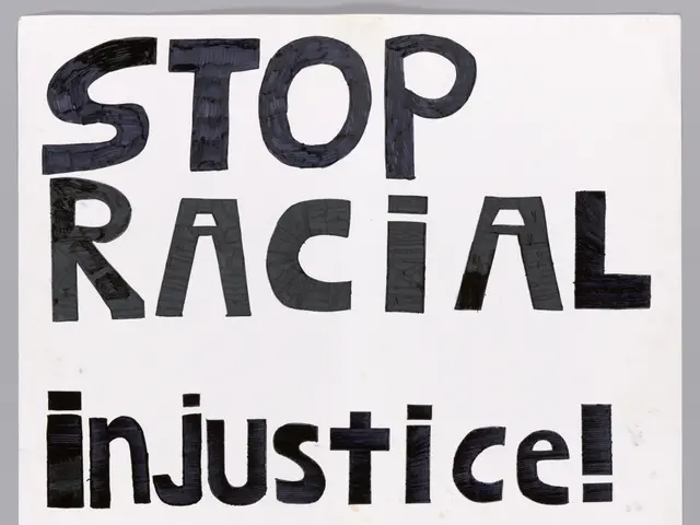 The image shows a white board with the words "Stop Racial Injustice" written in bold black...