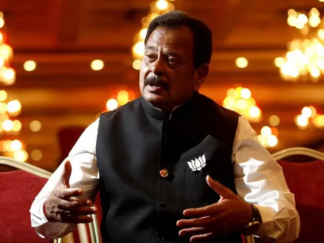 The image shows Shiv Sena Chief Uddhav Thackeray sitting on a chair in the foreground, with lights...