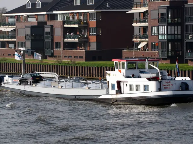 The image shows a boat traveling down a river, surrounded by tall buildings with windows, railings,...