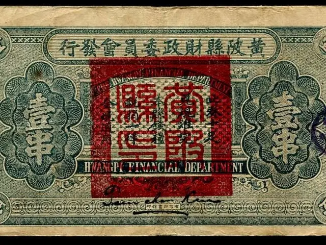 The image shows an old Chinese banknote with Chinese writing on it against a black background. The...