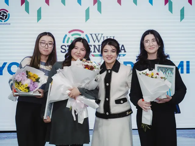 The image shows a group of four women standing next to each other, each holding a bouquet of...