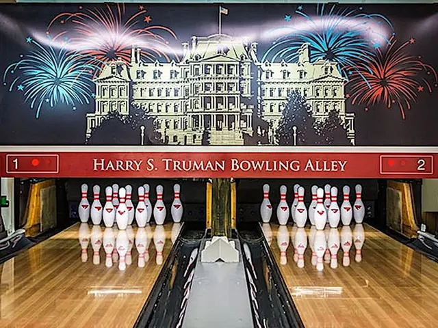 The image shows Harry S. Truman Bowling Alley, with bowling pins set up in the center of the room....