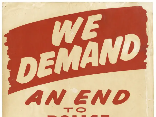 The image shows a poster with bold black text that reads "We Demand an End to Police Brutality...