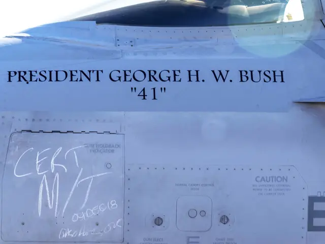 The image shows a close up of a fighter jet with the words "President George H.W. Bush" written on...