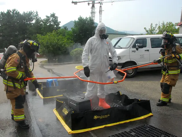 The image shows a group of firefighters in protective gear standing next to each other on a street....
