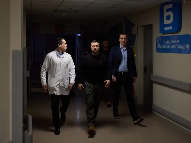 The image shows a group of men walking down a hospital hallway, illuminated by lights from the...