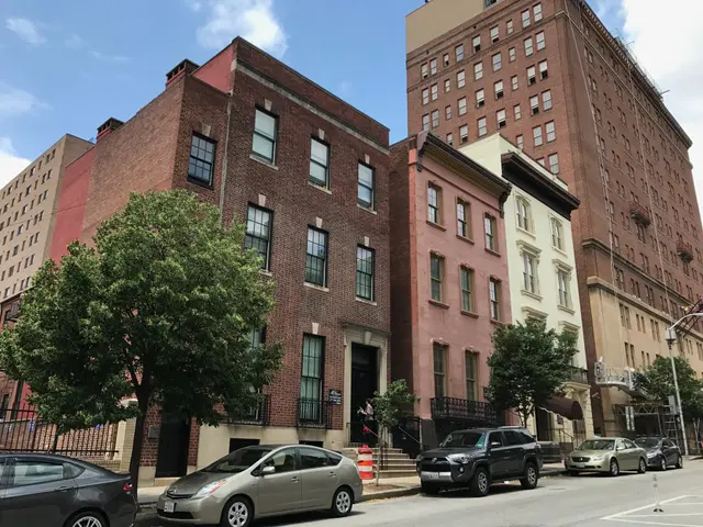 The image shows a street with cars parked on the side of it, surrounded by buildings with windows,...
