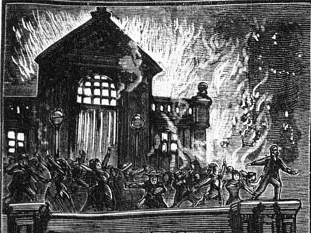 The image shows a black and white scene of a balcony during a fire, with a building engulfed in...