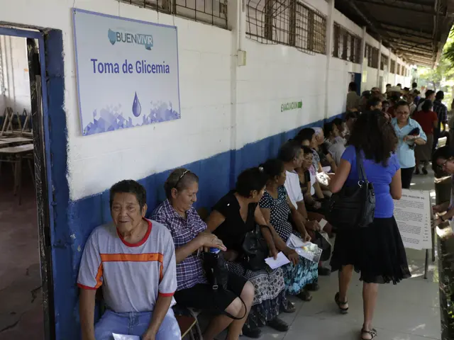 The image shows a group of people sitting on benches in front of a building, with some of them...