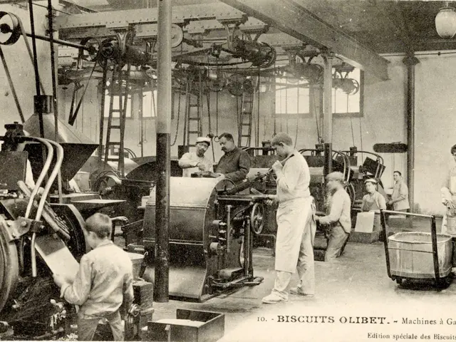 The image shows a group of men working in a factory, with machines, ladders, poles, lights,...