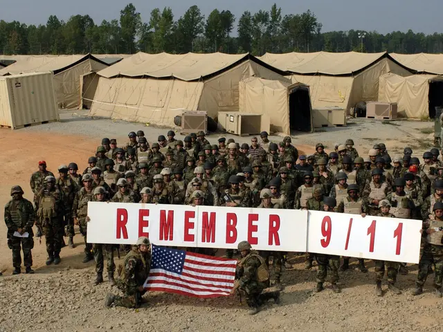 The image shows a group of soldiers wearing helmets and holding a banner that reads "Remember 9/11"...