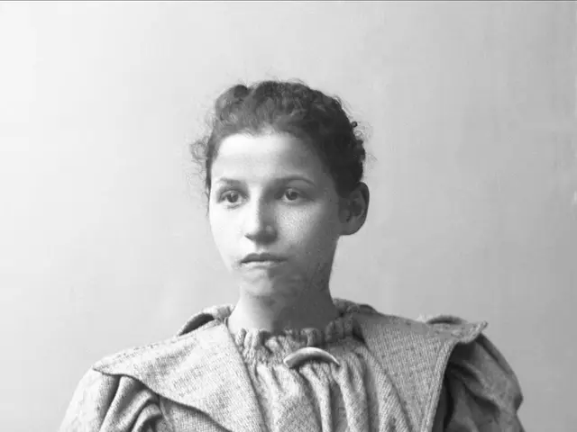 The image shows an old black and white photo of a woman in a dress, identified as Anna Maria...