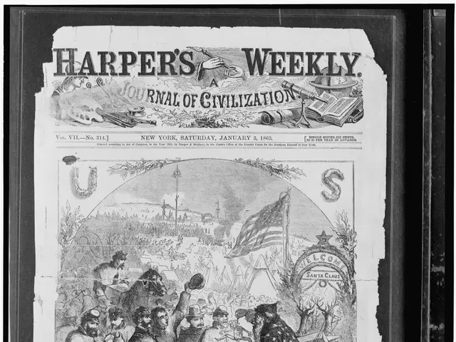 The image shows a black and white picture of a group of people gathered around a newspaper with the...