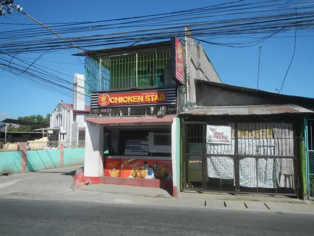 The image shows a chicken star restaurant on the corner of a street, surrounded by buildings,...