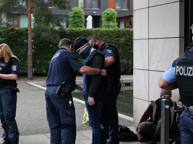 The image shows a group of police officers standing next to each other in front of a building, with...