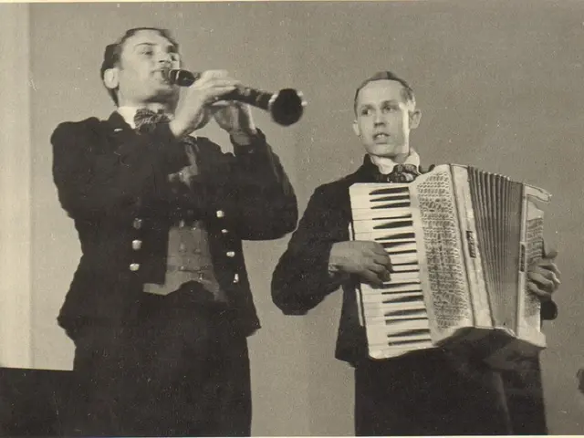 The image shows two men in military uniforms playing an accordion and singing into a microphone....