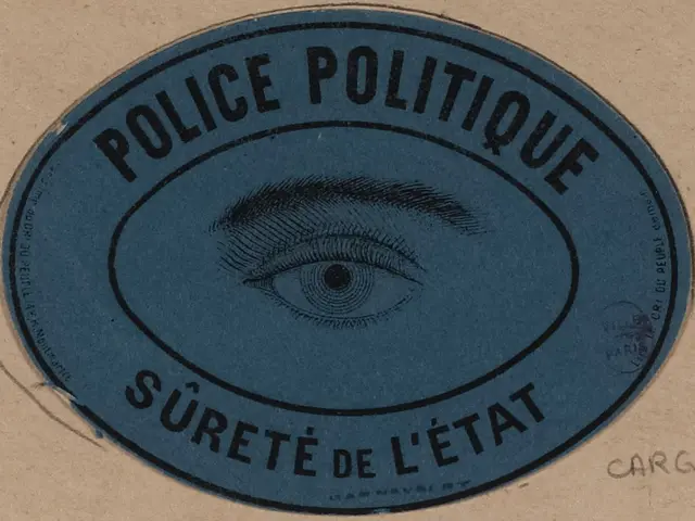 The image shows a brown cardboard box with a blue sticker on it that reads "Police Politique Surete...