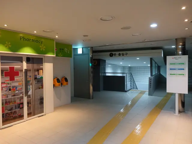 The image shows the entrance to a pharmacy with a sign that reads "Pharmacy" on the left side of...