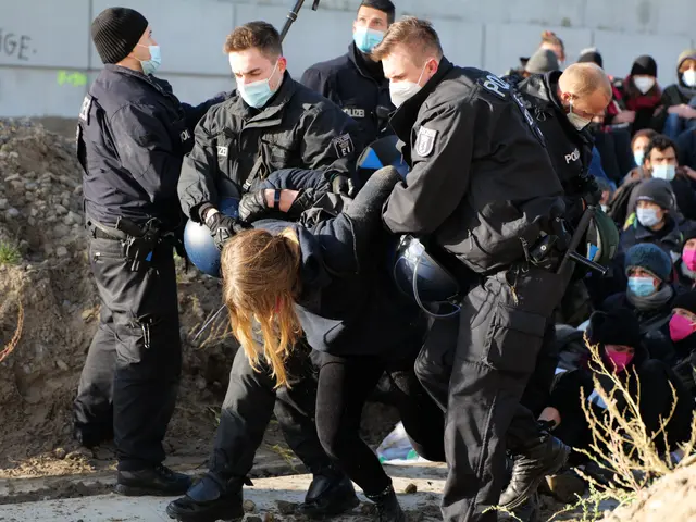 The image shows a group of people wearing masks and caps, some of them holding guns, gathered...