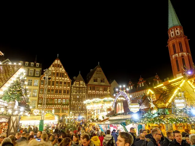 The image shows a bustling Christmas market in Nuremberg, Germany. There are many people gathered...