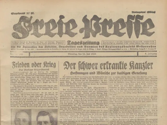 The image shows an old newspaper with a picture of two men on it. The newspaper is the front page...