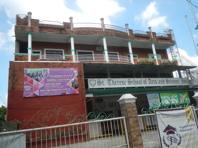 The image shows the St. Theresa School of Arts and Science, a building with windows, railings,...
