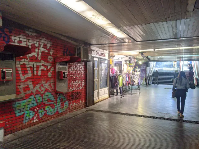 The image shows a woman walking through a subway station with graffiti on the walls. On the left...