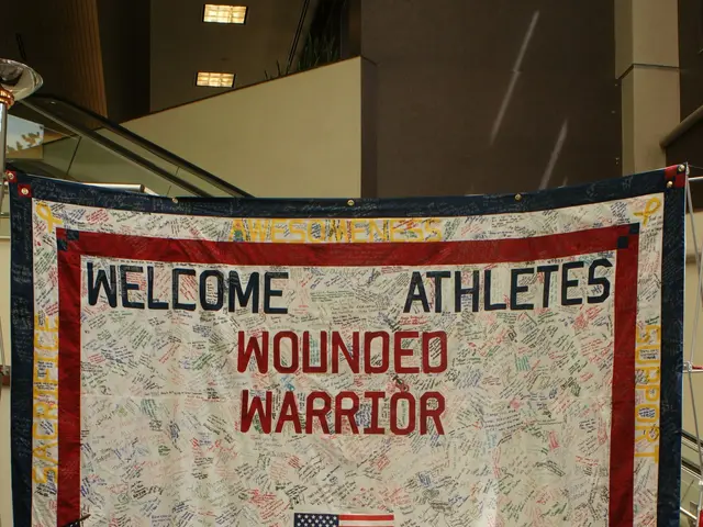 The image shows a banner with the words "Welcome Athletes Wounded Warrior" hanging from the...